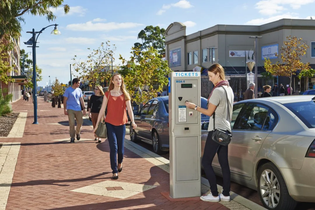 Photo of a person using a parking meter